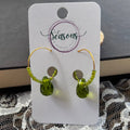 Green beaded earrings on aSeasons branded card with a lace fabric background